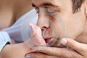 Father of baby kissing a leg