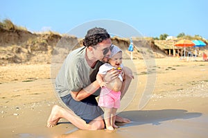 Father and baby newborn at the sea shore beach in summer family