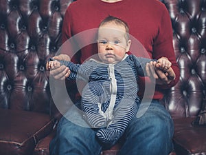 Father with baby on sofa