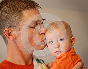 Father kissing his baby son