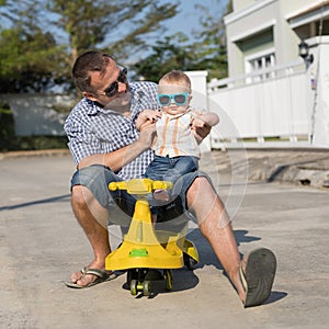 Father and baby son playing on the road at the day time