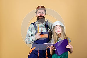 Father bearded man and daughter hard hat helmet uniform renovating home. Home improvement activity. Kid girl planning