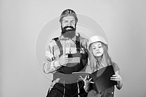 Father bearded man and daughter hard hat helmet uniform renovating home. Home improvement activity. Kid girl planning