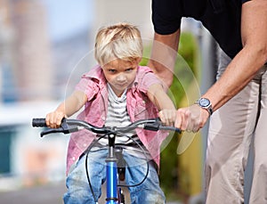 Father, bike and teaching child to ride in outdoor, bonding together and wellness with childhood development. Parent