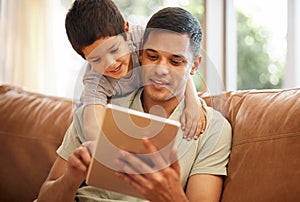 Father, boy and child with tablet on sofa for online games, reading ebook story and elearning multimedia. Man, dad and
