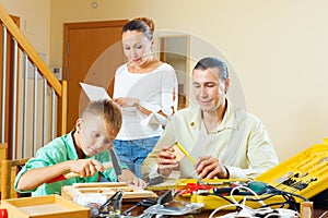 Father and boy spend their free time with working tools