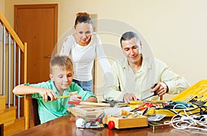 Father and boy spend their free time with working tools