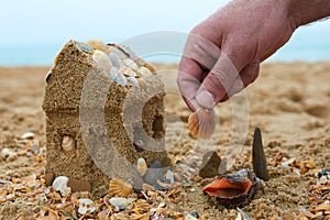 Father building a sand house on a seashore