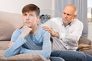 Father calming upset teenage son