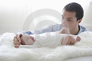 Father Caressing Newborn Baby's Head photo