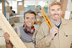 father carpenter and son in workshop