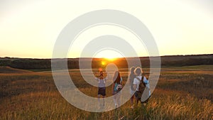 Father carries a little daughter on his shoulders, a happy family travels in the park. Family with children travels on