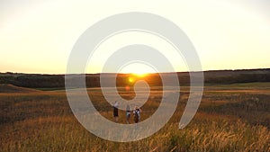 Father carries a little daughter on his shoulders, a happy family travels in the park. Family with children travels on