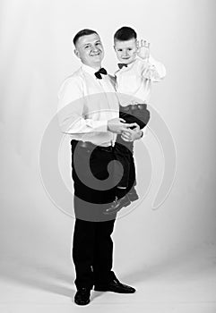 Father carry hug son formal clothes outfit. Grow up gentleman. Gentleman upbringing. Little son following fathers