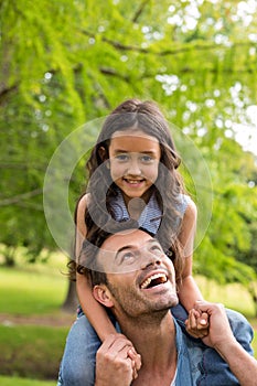 Father carrying daughter on his shoulders