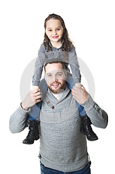 Father carrying daughter on his shoulders, studio shot