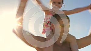 Father Carrying Daughter On Shoulders Spinning Around