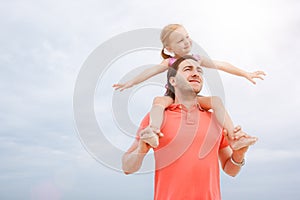 Father carrying his daughter on shoulders