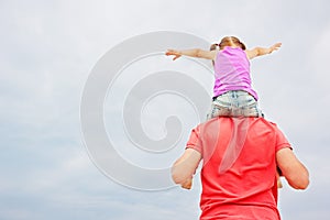 Father carrying his daughter on shoulders