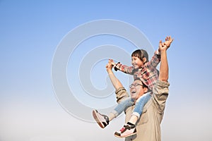 Father carrying his daughter on shoulders