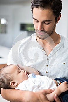 Father carrying sleeping baby