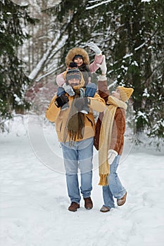Father Carrying Smiling Girl on Shoulders in Winter photo