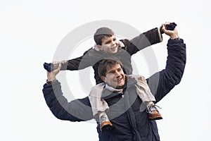 Father Carrying Son On His Shoulders