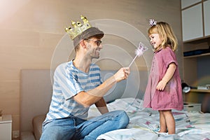 Father casting spell on daughter with magic wand