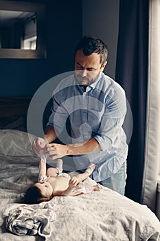 Father changing diaper for newborn baby