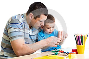 Father and child boy play clay together