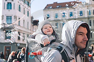 Father with child celebrate carnival at old center of Ljubljana,