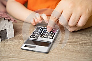 Father and child count on a calculator. Concept of budget planning and payment of utility bills.