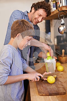 Father, child and fruit for lemonade in home for nutrition on kitchen counter for breakfast, beverage or diet. Male