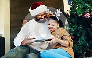 Father, child and giving christmas gift for holiday celebration with family, love and care while together and happy at
