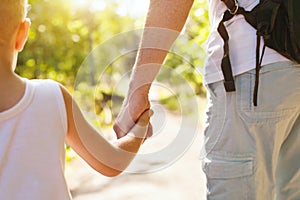 Father and child holding hands