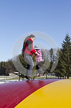 Father and child jumping on trampoline
