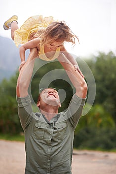 Father, child and lifting outdoor for play together in nature on holiday vacation for love connection, game or adventure