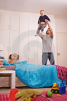 Father, child and plane in bedroom with playing for bonding, healthy relationship and happiness in home. Family, dad and