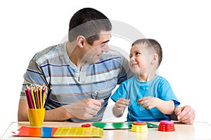 Father and child play with clay together