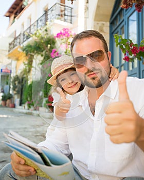 Father and child showing thumbs up