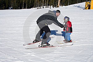 Father and child skiing