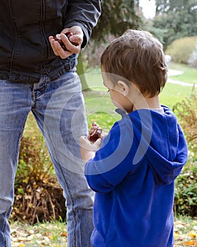 Father and child son in autumn park