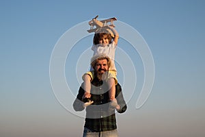 Father and child son playing outside. Memories of childhood. Child pilot aviator with airplane dreams of traveling in