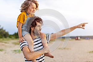 Father with a child spending the day at the beach