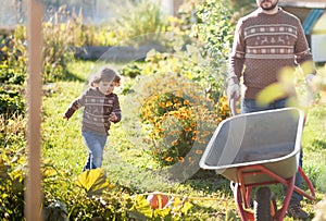 Father and child working in the garden.