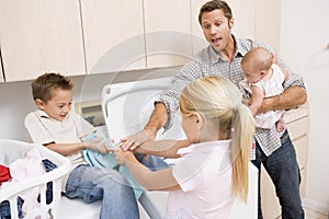 Father And Children Doing Laundry