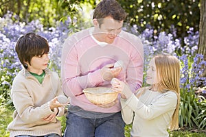 Father and children on Easter looking for eggs