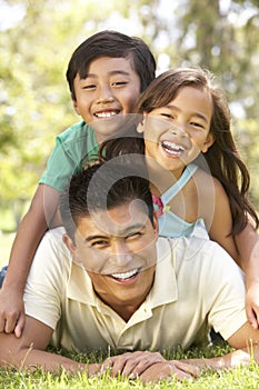 Father And Children Enjoying Day In Park