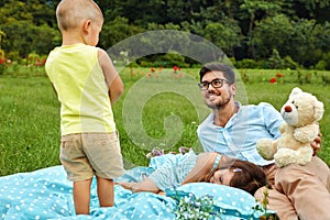 Father With Children Having Fun In Park. Happy Family In Nature