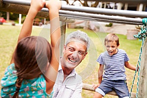 Father with children having fun at a playground